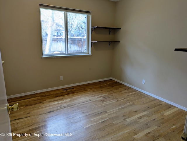 spare room featuring light hardwood / wood-style floors