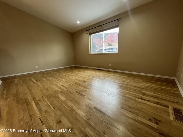 empty room with light hardwood / wood-style flooring