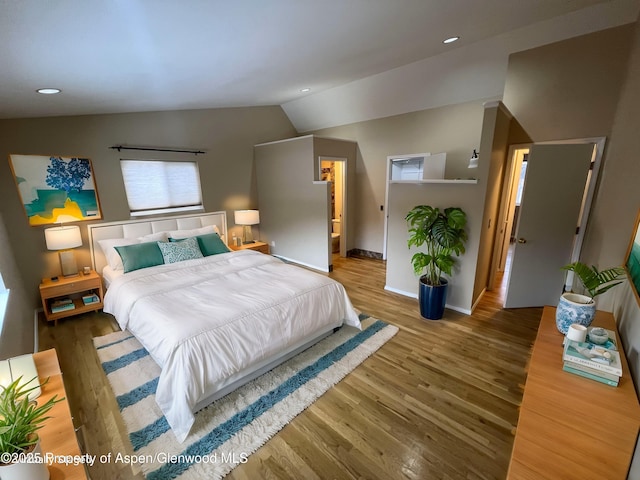 bedroom with wood-type flooring and lofted ceiling