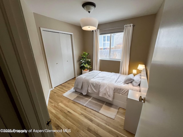 bedroom with a closet and light wood-type flooring