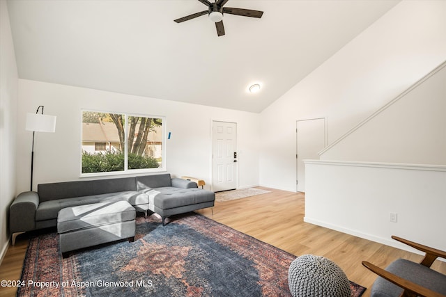 living room featuring hardwood / wood-style flooring, ceiling fan, and high vaulted ceiling