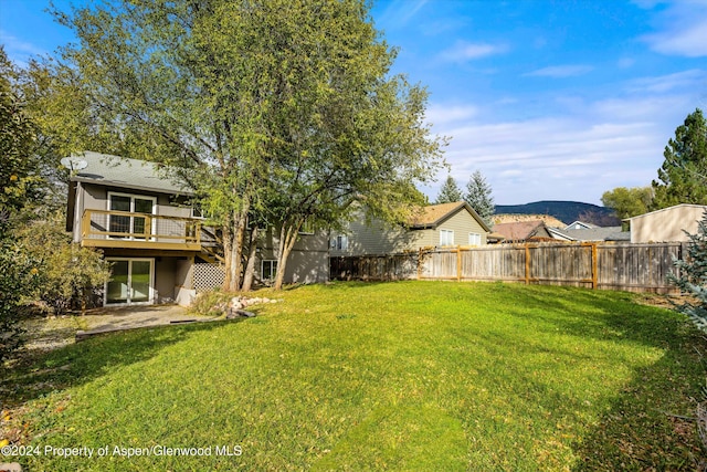 view of yard featuring a deck with mountain view