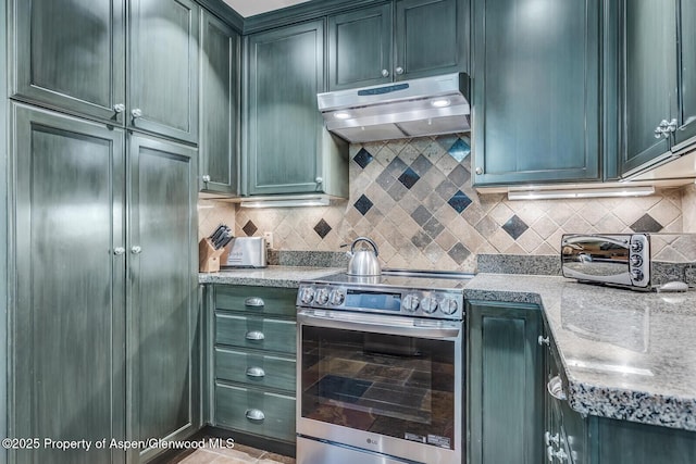 851 Ute Ave Unit B, Aspen, CO 81611 - kitchen with stainless steel electric range, under cabinet range hood, decorative backsplash, and light stone countertops