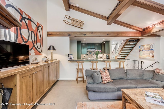 851 Ute Ave Unit B, Aspen, CO 81611 - living area featuring light colored carpet, beamed ceiling, high vaulted ceiling, and stairway