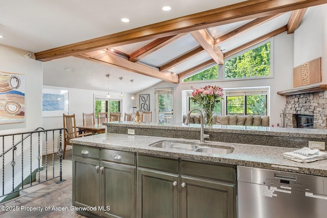 851 Ute Ave Unit B, Aspen, CO 81611 - kitchen featuring dishwasher, light stone counters, a fireplace, pendant lighting, and open floor plan