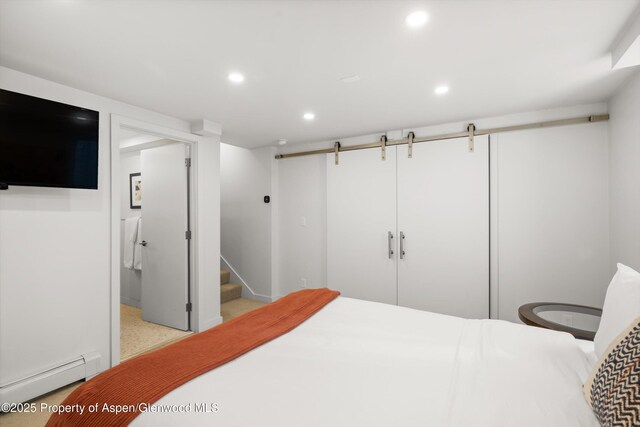 250 S Original St Unit B, Aspen, CO 81611 - bedroom with a baseboard heating unit, recessed lighting, a closet, a barn door, and baseboards