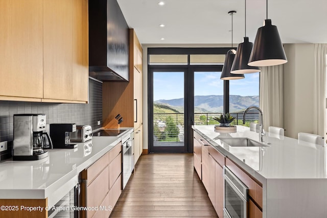 77 Wood Rd Unit 507-13, Snowmass Village, CO 81615 - kitchen featuring a sink, wall chimney range hood, modern cabinets, hardwood / wood-style floors, and recessed lighting