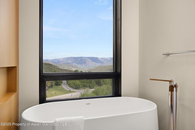 77 Wood Rd Unit 507-13, Snowmass Village, CO 81615 - full bathroom with a freestanding tub and a mountain view