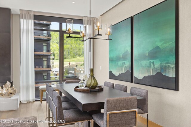 77 Wood Rd Unit 507-13, Snowmass Village, CO 81615 - dining room featuring wood finished floors and a chandelier