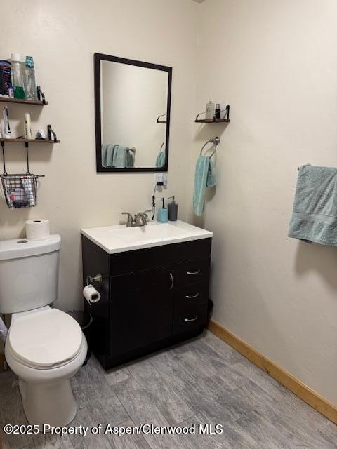 763 Tucker St, Craig, CO 81625 - half bathroom featuring vanity and toilet
