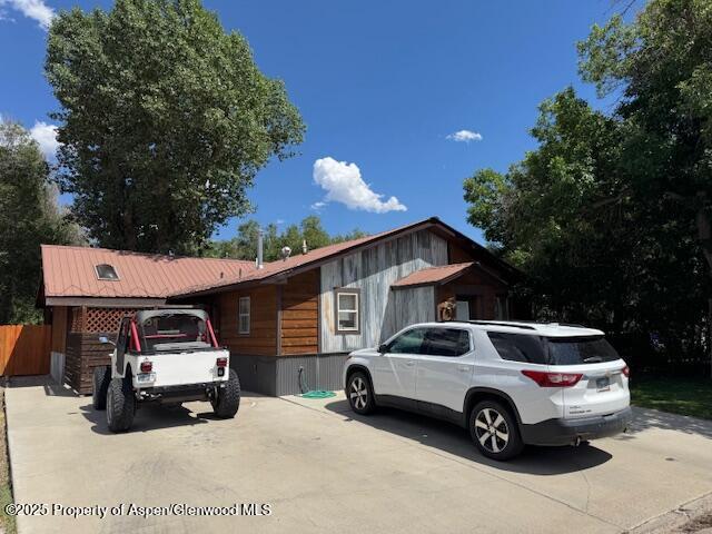 763 Tucker St, Craig, CO 81625 - view of front facade with concrete driveway and a metal roof