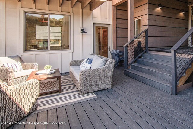 wooden terrace with outdoor lounge area