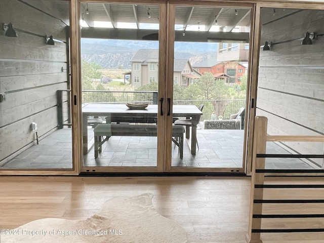 entryway featuring wooden walls and wood-type flooring