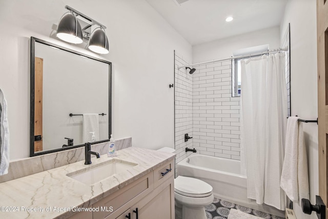 full bathroom featuring shower / bath combo with shower curtain, vanity, and toilet