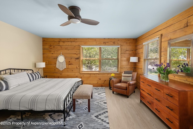 1436 Hooks Spur Rd, Basalt, CO 81621 - bedroom featuring multiple windows, light wood finished floors, wooden walls, and ceiling fan