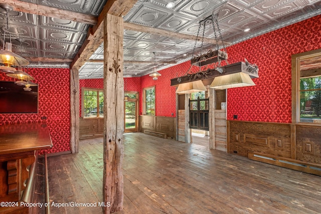 interior space with hardwood / wood-style flooring and a baseboard heating unit