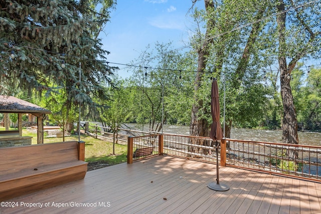 wooden terrace with a water view