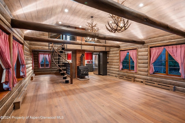 workout area featuring rustic walls, a baseboard heating unit, hardwood / wood-style flooring, wooden ceiling, and a wood stove