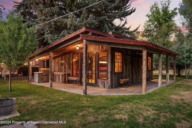 exterior space featuring a yard and an outdoor kitchen