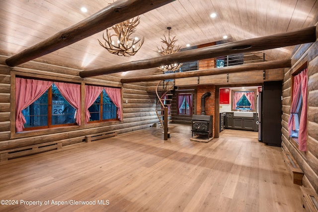 interior space with a wood stove, rustic walls, wooden ceiling, and beam ceiling