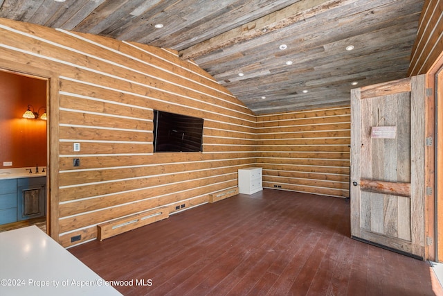 unfurnished room with dark hardwood / wood-style flooring, sink, wooden ceiling, lofted ceiling, and wood walls