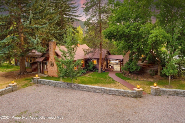 log-style house featuring a yard