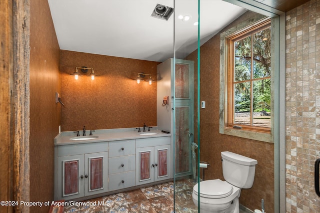 bathroom featuring vanity, a healthy amount of sunlight, and toilet