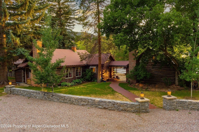 log-style house with a front lawn