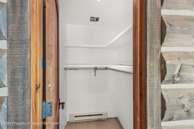 closet with a baseboard heating unit