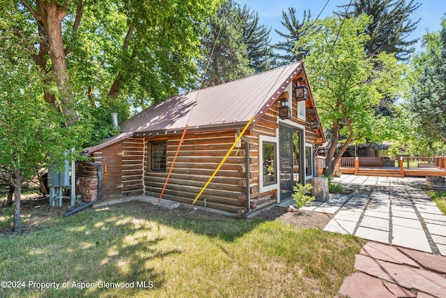 exterior space with a patio, a yard, and a deck