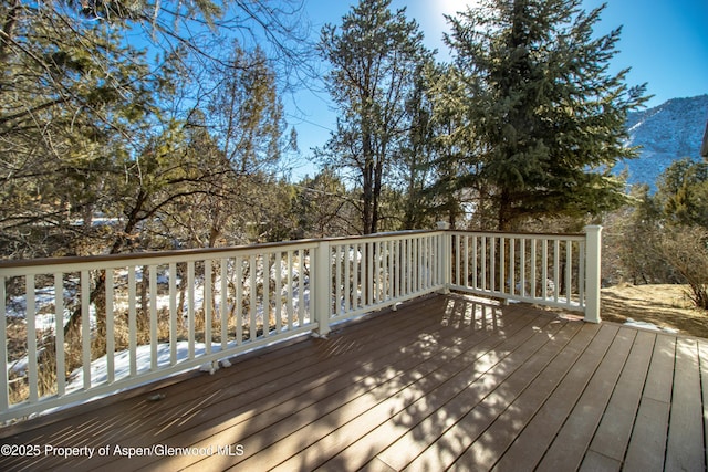 wooden deck with a mountain view