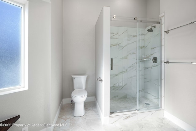 bathroom featuring toilet and a shower with shower door