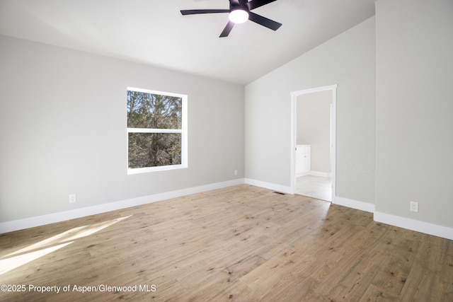 spare room with vaulted ceiling, ceiling fan, and hardwood / wood-style floors