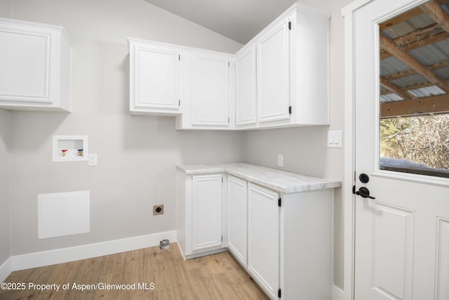 clothes washing area featuring washer hookup, cabinets, light hardwood / wood-style flooring, and hookup for an electric dryer