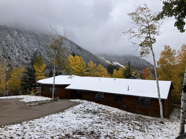 view of snowy exterior with a mountain view