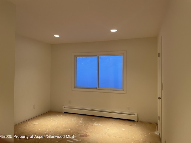 unfurnished room with a baseboard radiator