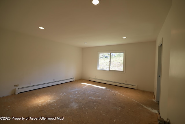 empty room featuring a baseboard heating unit