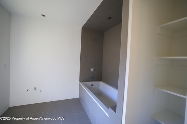 bathroom with tile patterned flooring and tiled shower / bath