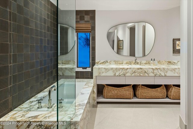 bathroom featuring vanity, tile patterned floors, walk in shower, and tile walls