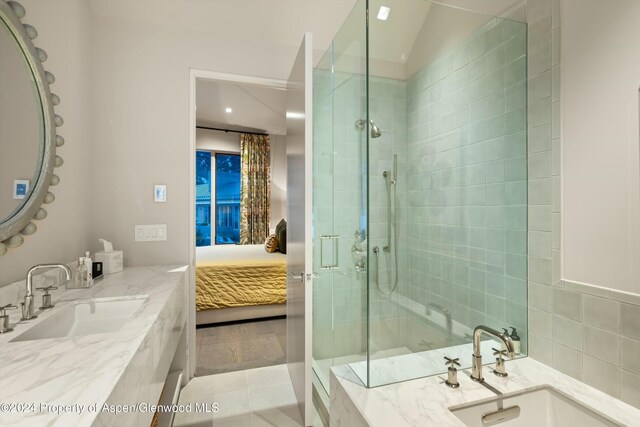 bathroom with tile patterned floors, vanity, vaulted ceiling, and a shower with shower door