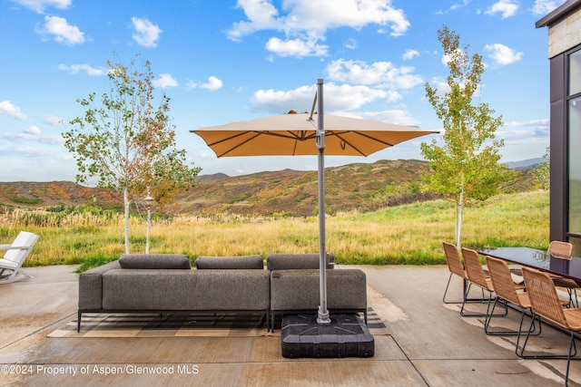 view of patio / terrace with a mountain view and an outdoor living space