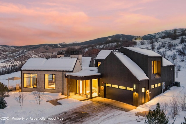 view of front of property featuring a mountain view and a garage