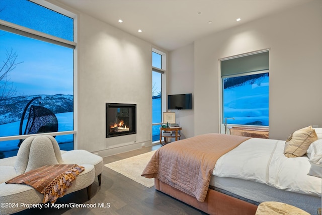 bedroom with a fireplace and hardwood / wood-style floors