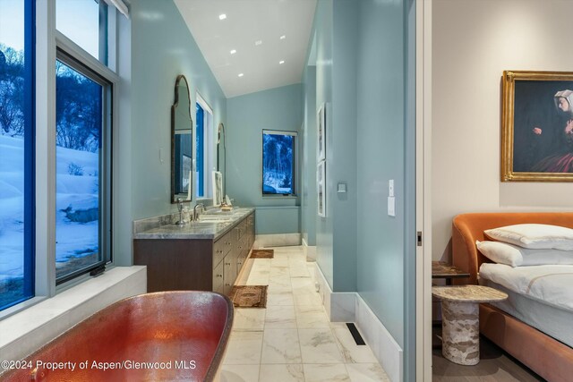 387 Branding Ln, Snowmass Village, CO 81615 - bathroom with marble look tiles, double vanity, lofted ceiling, and recessed lighting