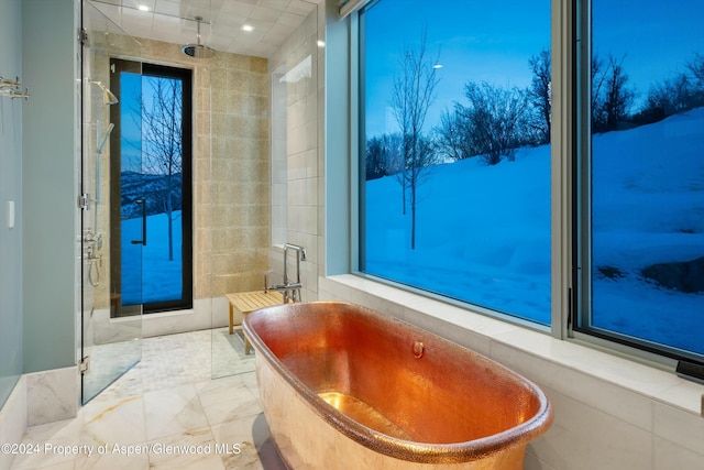 bathroom featuring separate shower and tub