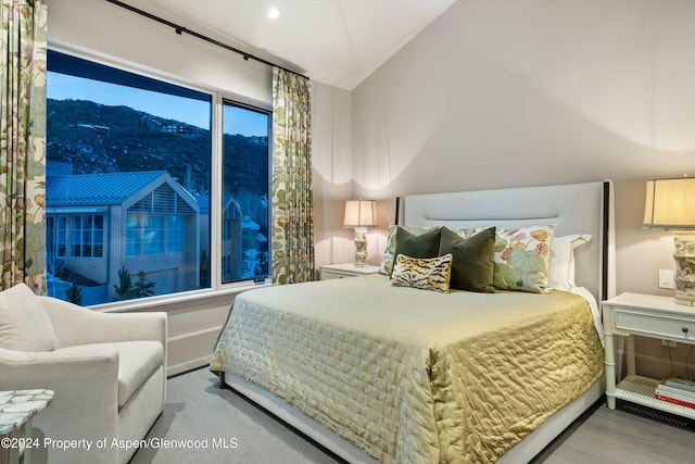 bedroom featuring a mountain view and lofted ceiling