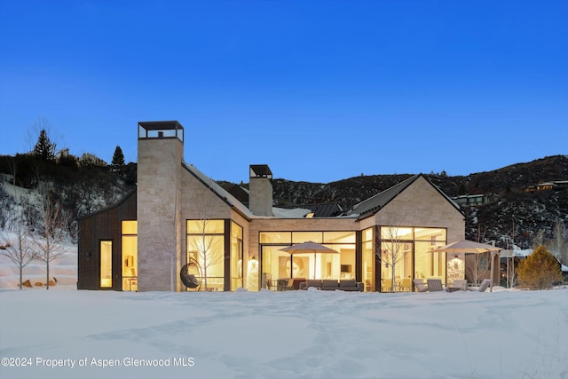 387 Branding Ln, Snowmass Village, CO 81615 - snow covered rear of property featuring a chimney