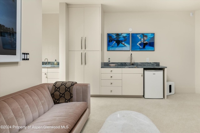 interior space with light colored carpet and indoor wet bar