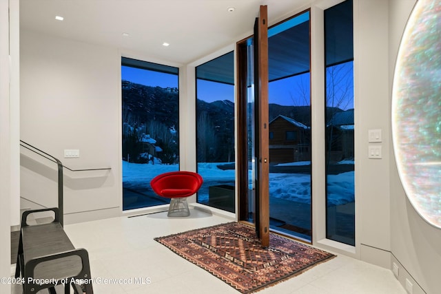 entryway featuring a mountain view and floor to ceiling windows