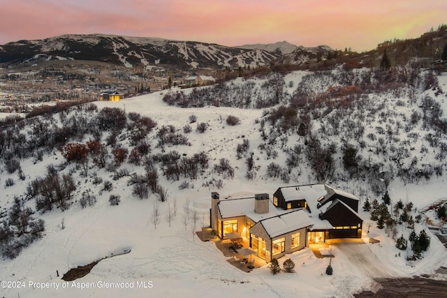 snowy aerial view featuring a mountain view